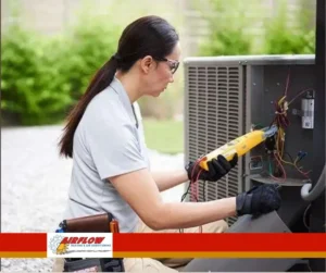 Technician performing routine maintenance on a residential central air conditioning system