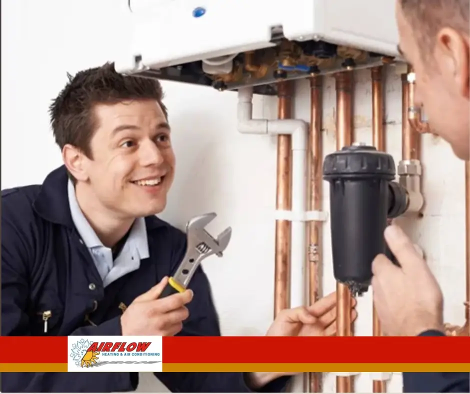 Professional technician installing a residential furnace to improve home heating efficiency.